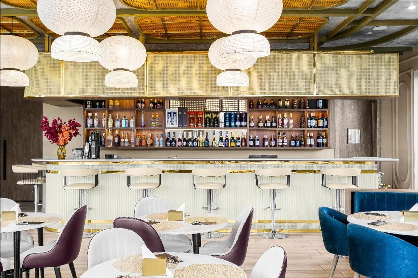 Hotel bar with gold accents and velvet chairs