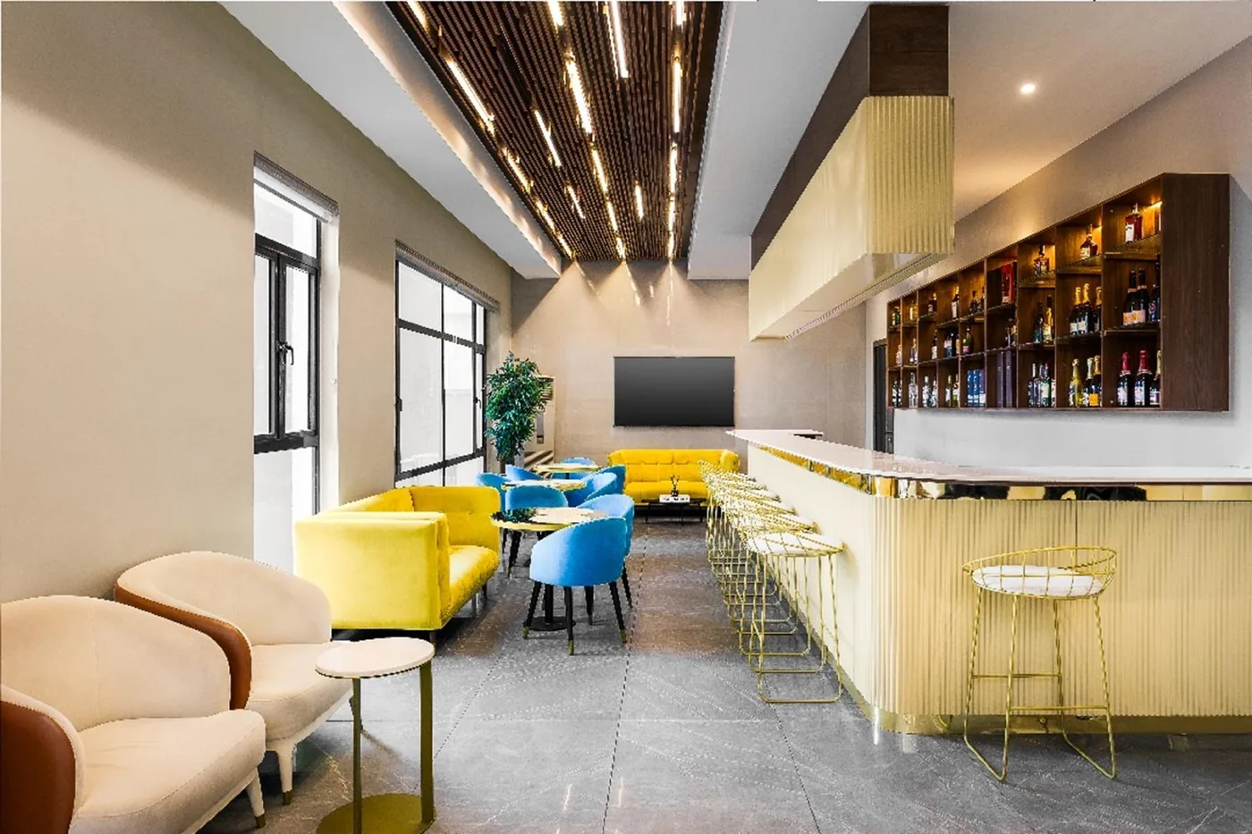 Lounge seating with yellow sofas beside the bar