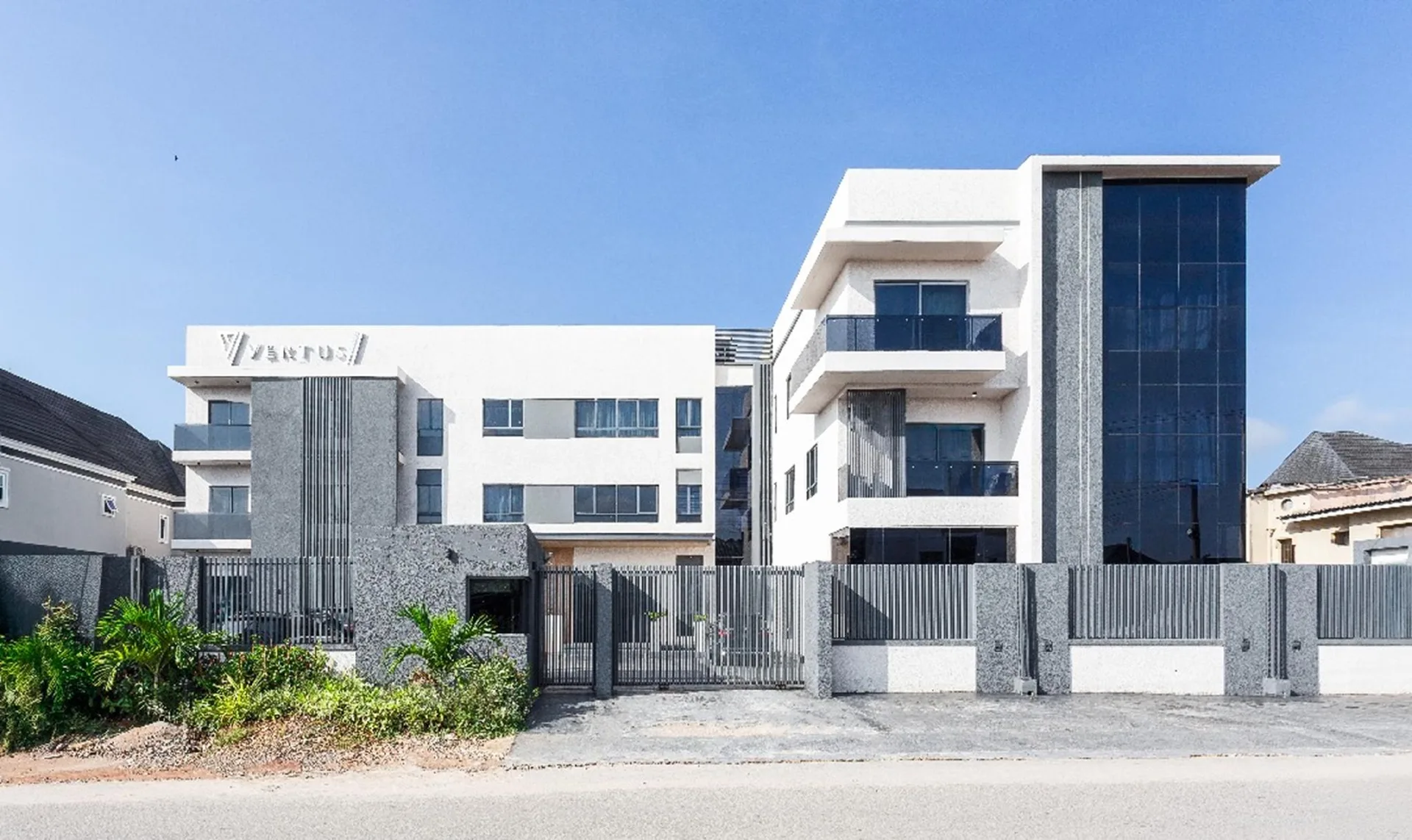 The modern white and charcoal exterior of Vertus Hotel